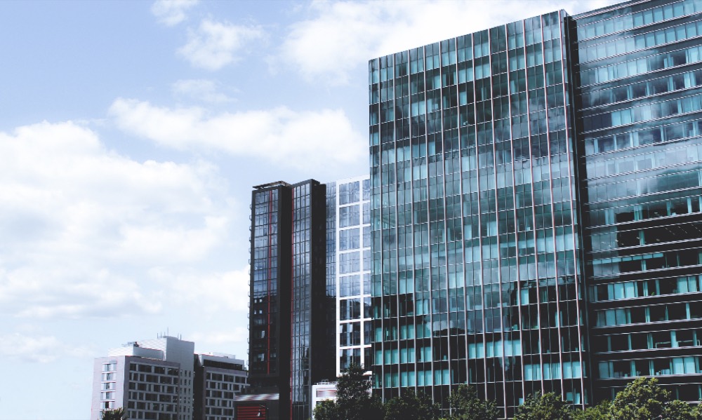A cluster of corporate office towers, standing in for the many separate companies that share a similar name