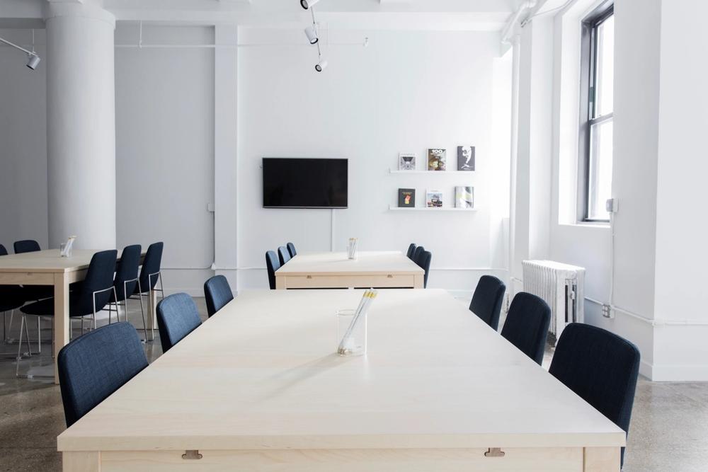 Directors at a meeting table discussing a company purchase, representing a company borrowing for a business purpose