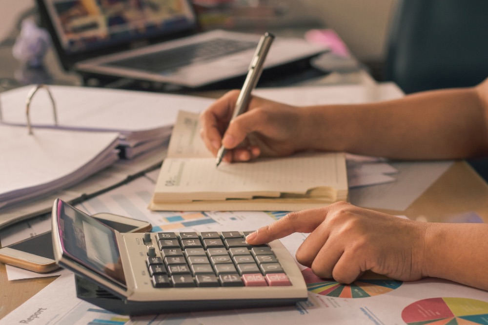 A director at a desk considering a decision, representing the duty of care in a borrowing choice